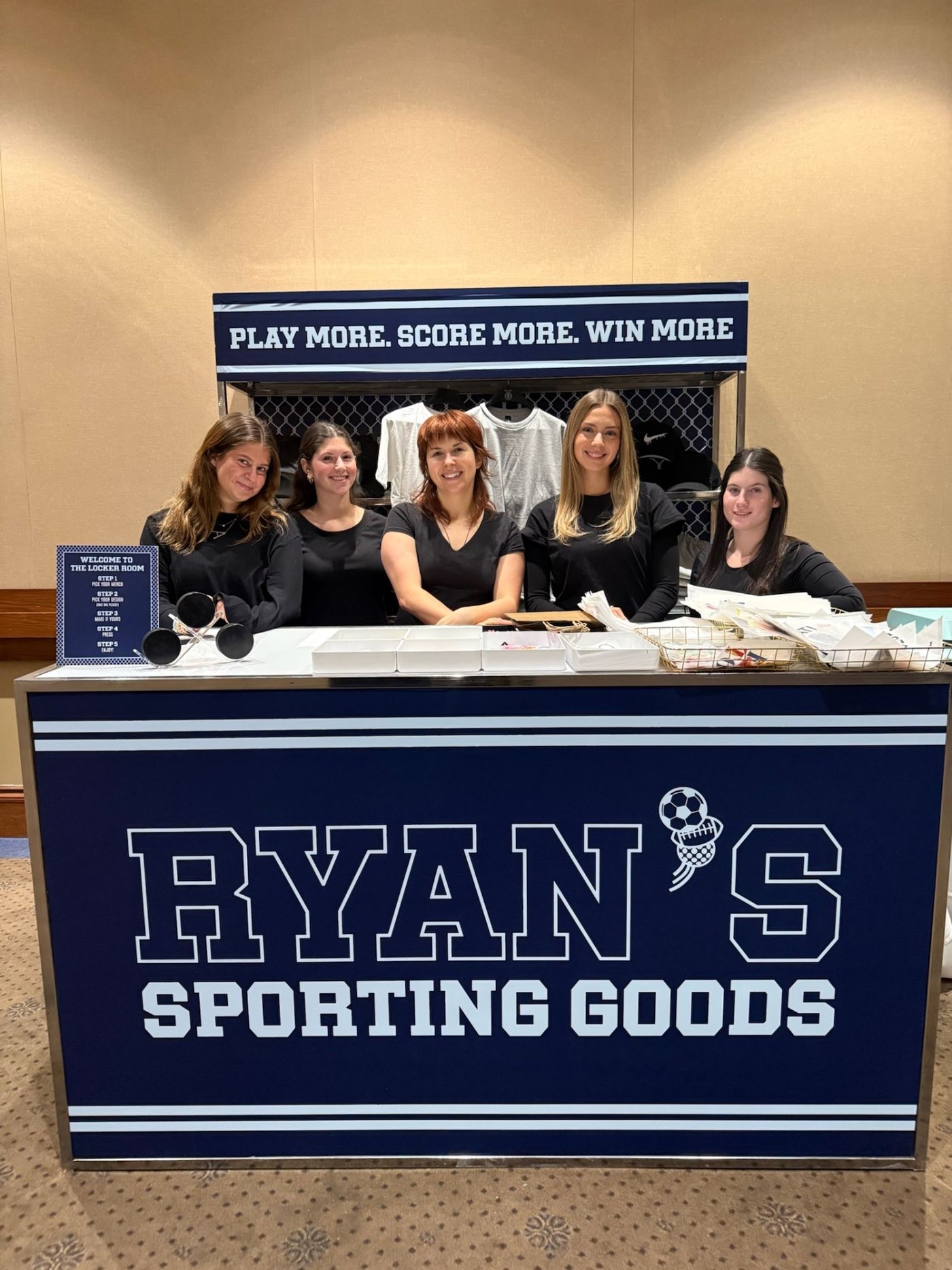 Ryan's Sporting Goods locker room merch booth with team